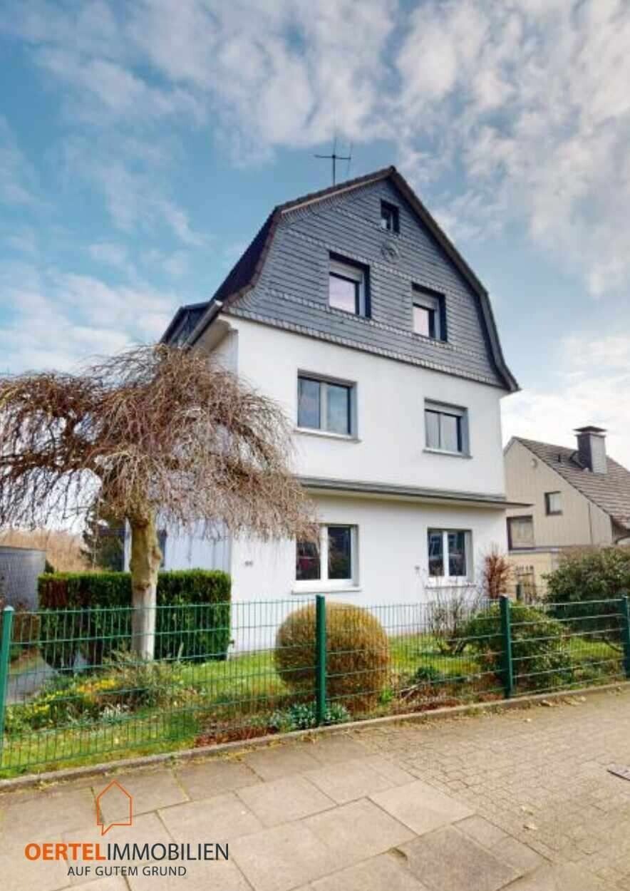 Mehrfamilienhaus mit drei Wohneinheiten, Anbau mit Garagen, Stellplätzen und Garten